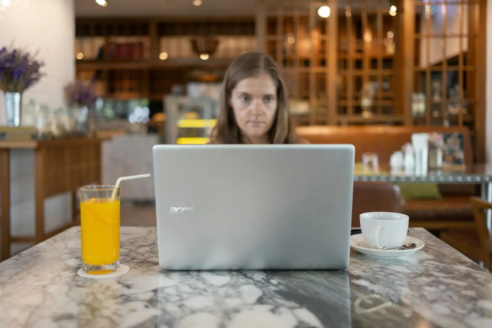 Business owner working on a laptop at a café table