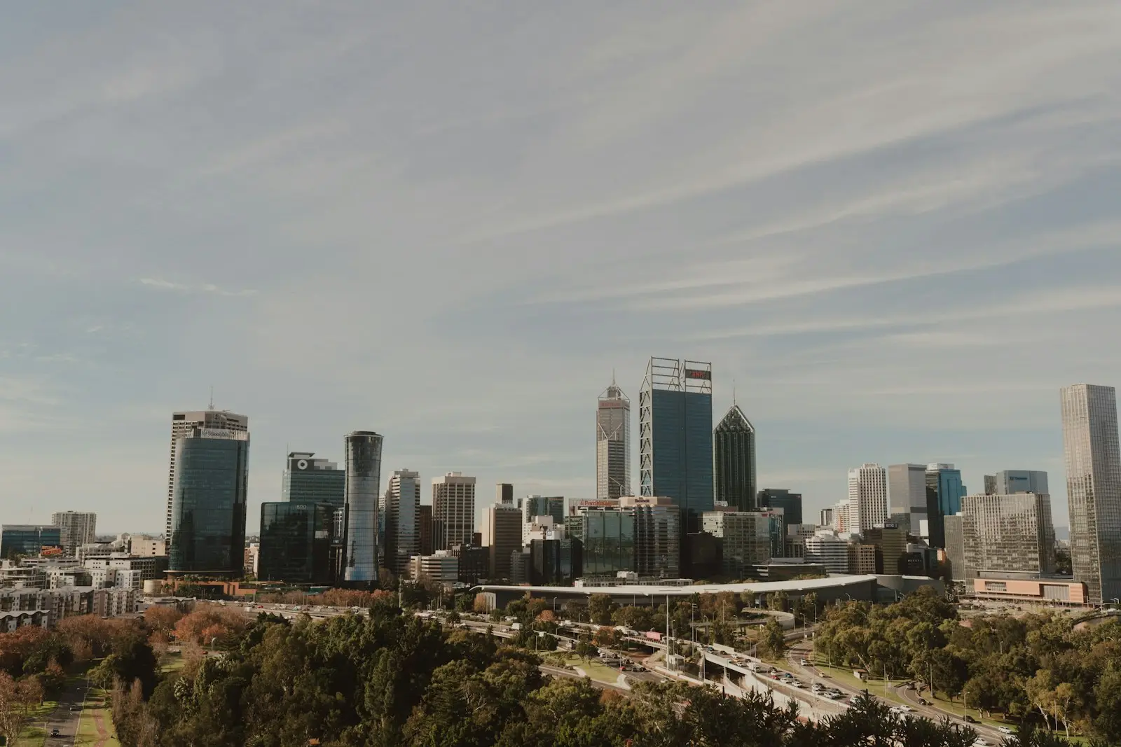 City skyline with office towers beside a green park