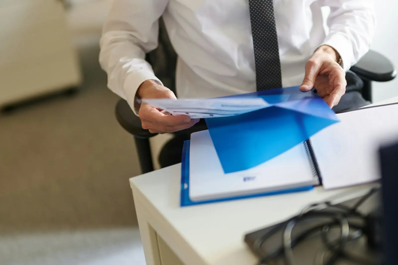 Business owner holding a folder of paperwork