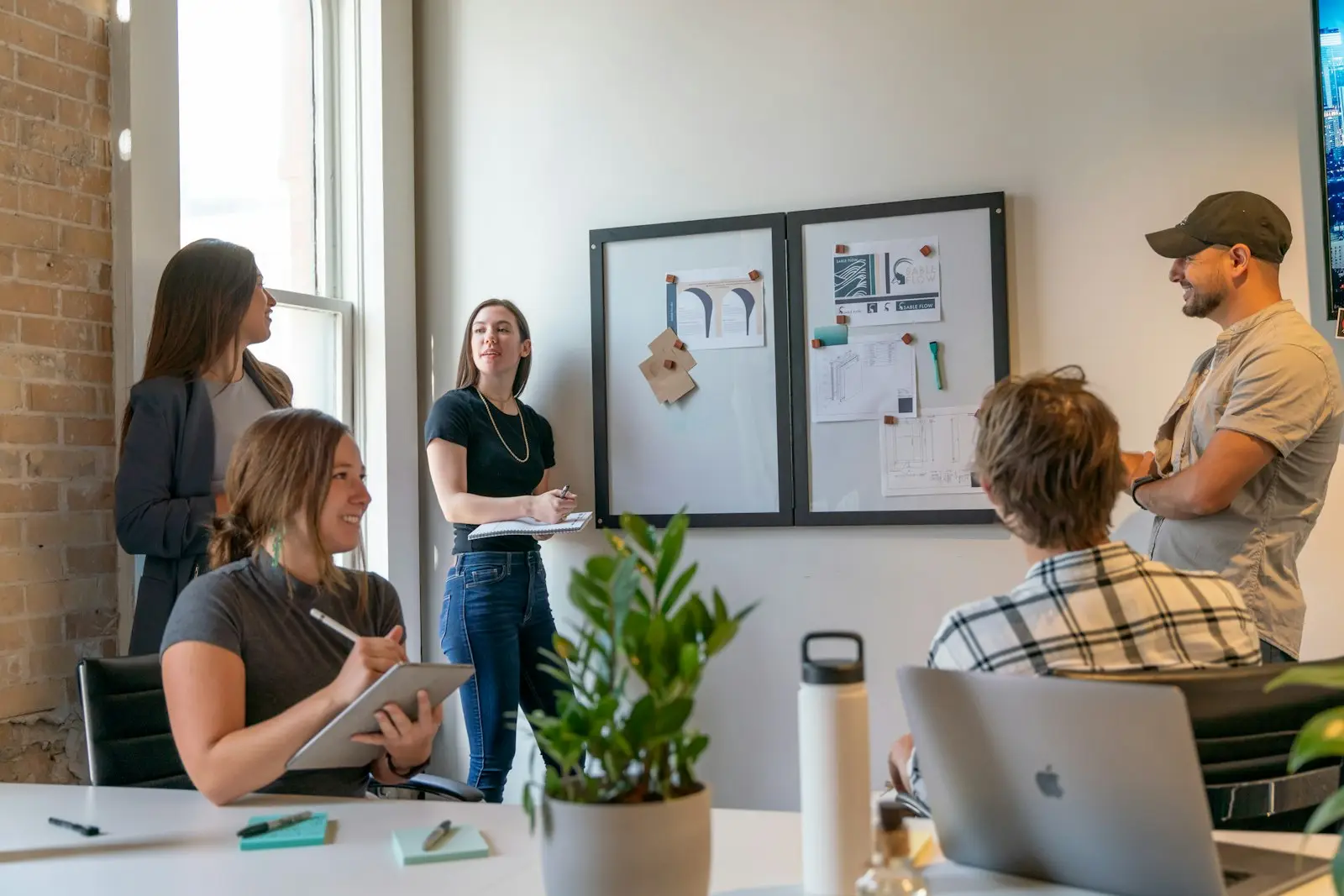Small business team meeting around a table in a sunlit office