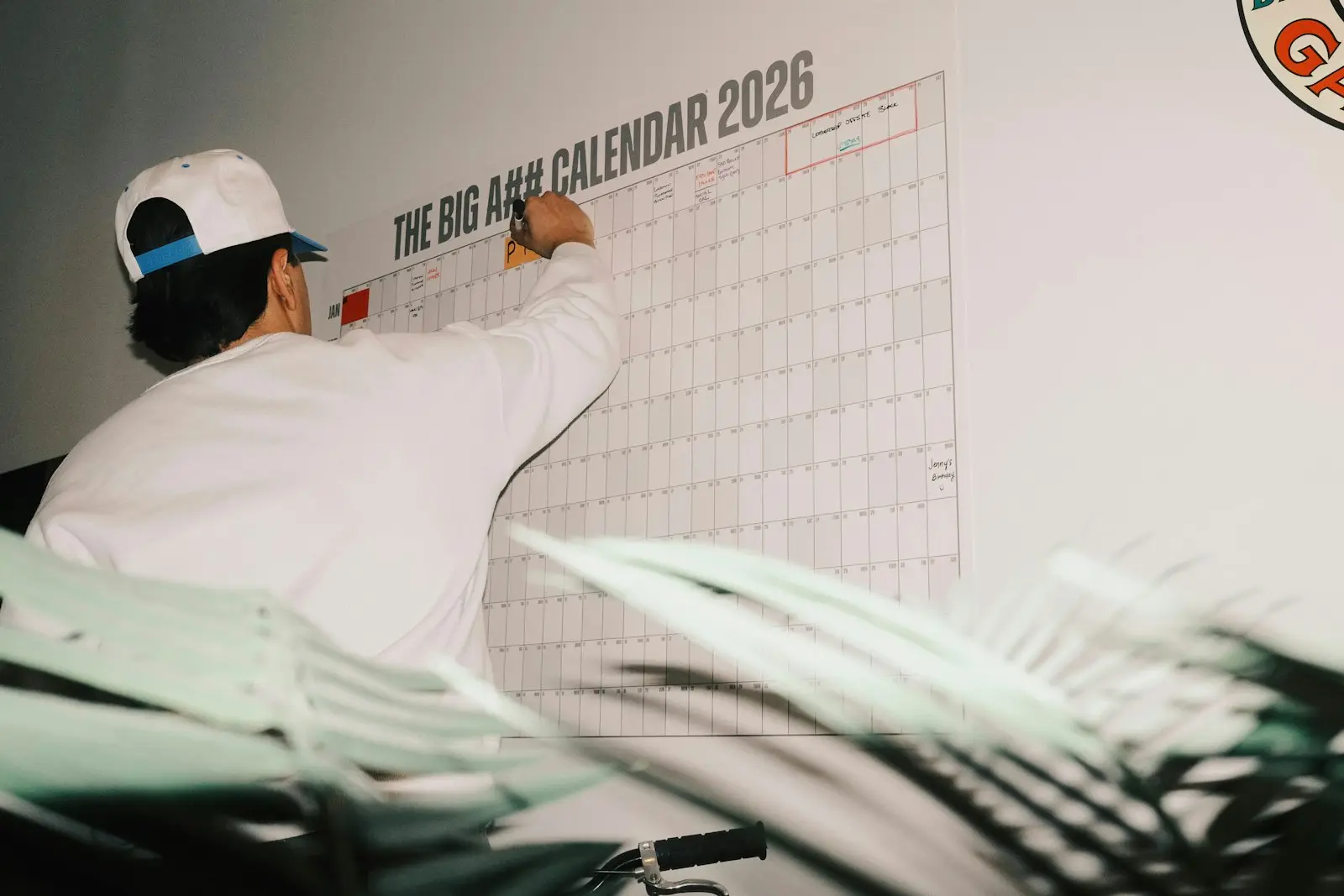 Marking key dates on a large 2026 wall calendar